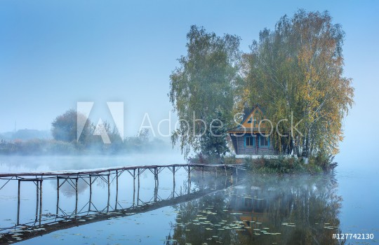 Picture of blue foggy morning with embankment to fishing house